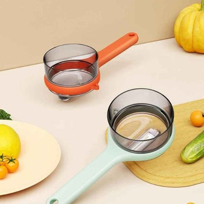 Éplucheur à légumes en deux coloris vert et orange
